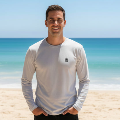 Man wearing a 100 % Cotton Dew white long-sleeve shirt with a Dew embroidered logo on a beach