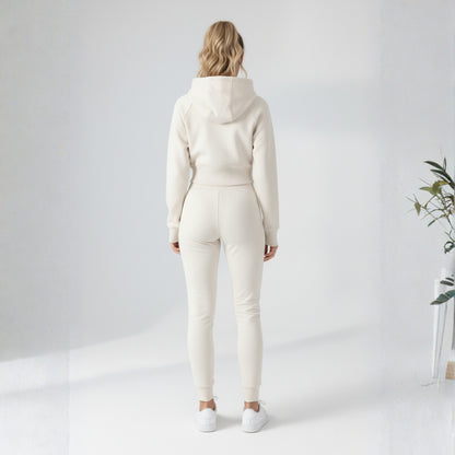 Person wearing a cream-colored Dew Women's Premium Crop Zip Jacket against a white background