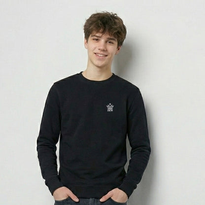 Person wearing a  black Dew Classic Jumper with a logo on a plain background
