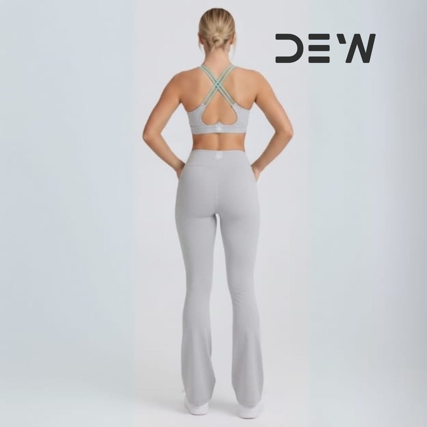 Back view of high-waist fit and core support on grey flare leggings.