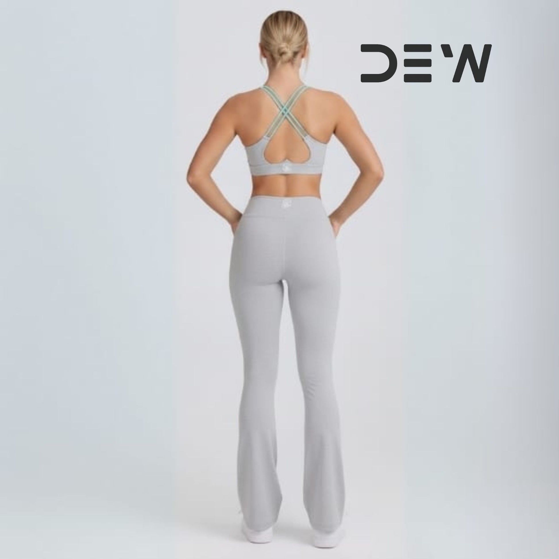 Back view of high-waist fit and core support on grey flare leggings.