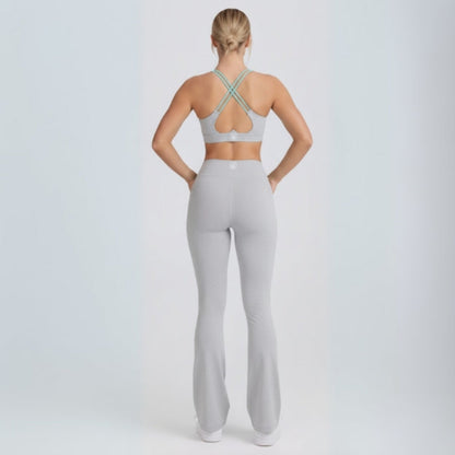Person wearing a gray sports bra and Dew Flow fit flares leggings set on a white background