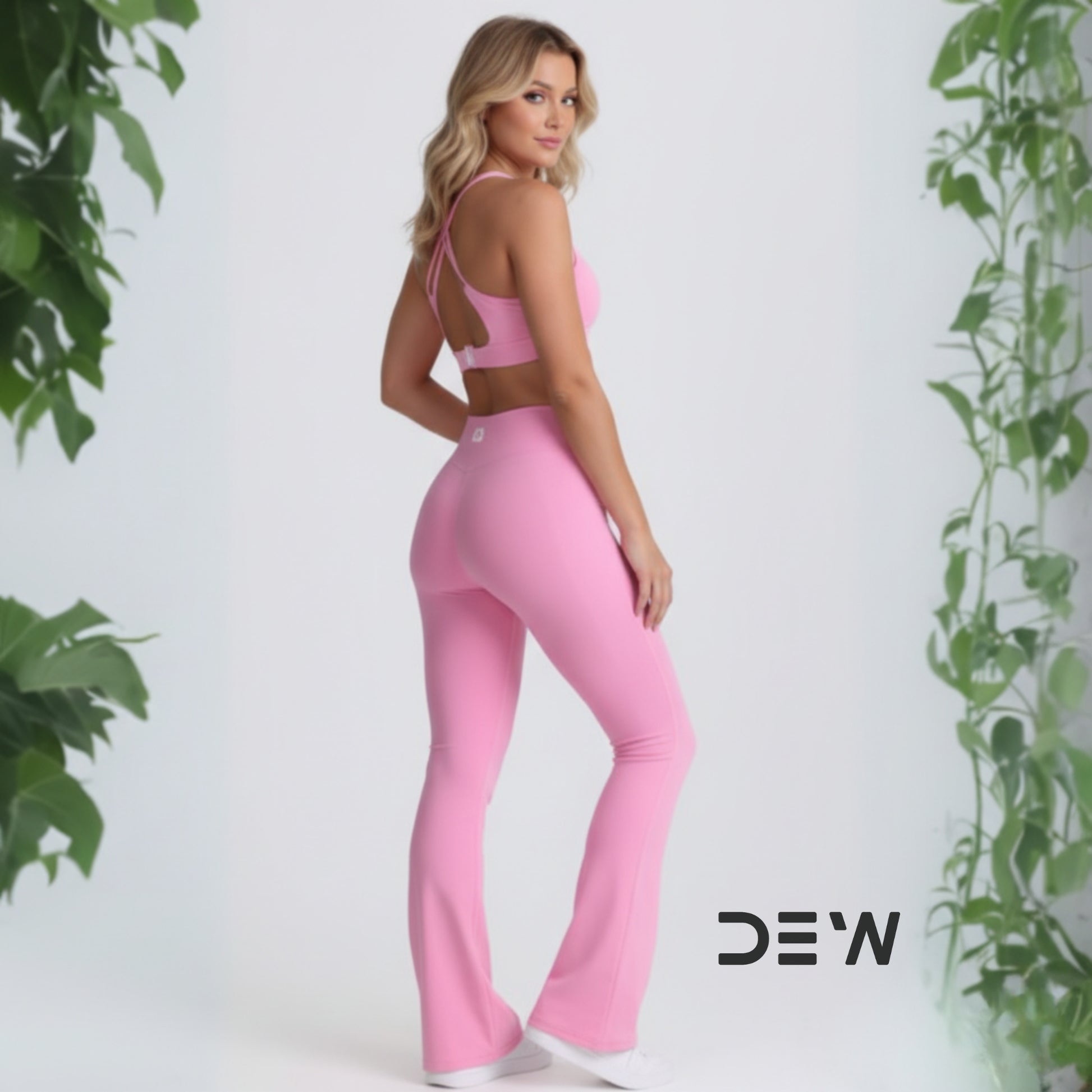 Rear view of pink seamless Flow Fit Flare leggings and strappy open-back sports bra. Highlights fit and design detail.