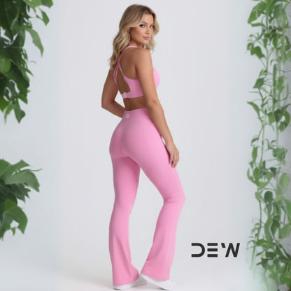 Rear view of pink seamless Flow Fit Flare leggings and strappy open-back sports bra. Highlights fit and design detail.